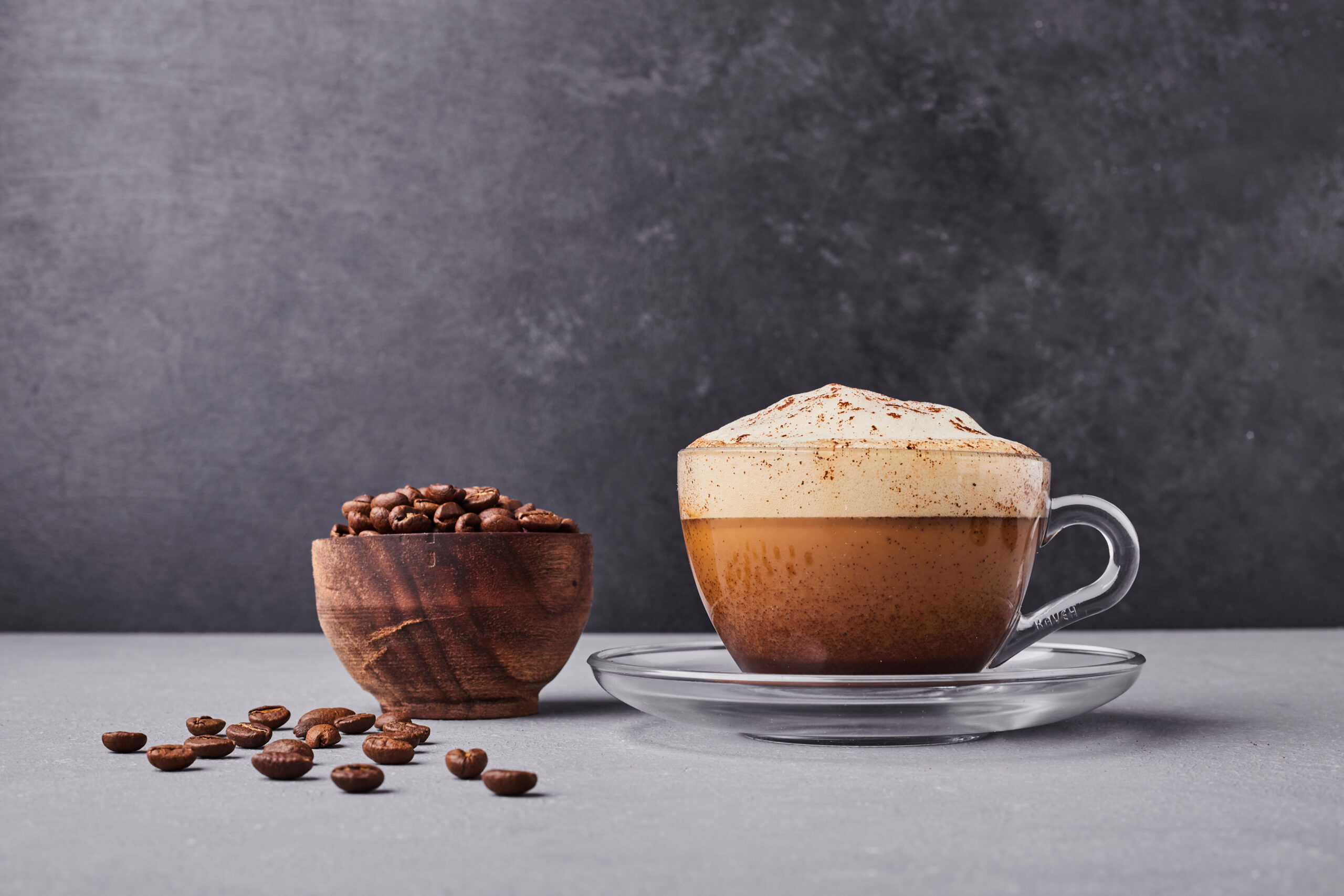 cup cappuccino with coffee beans around scaled 1